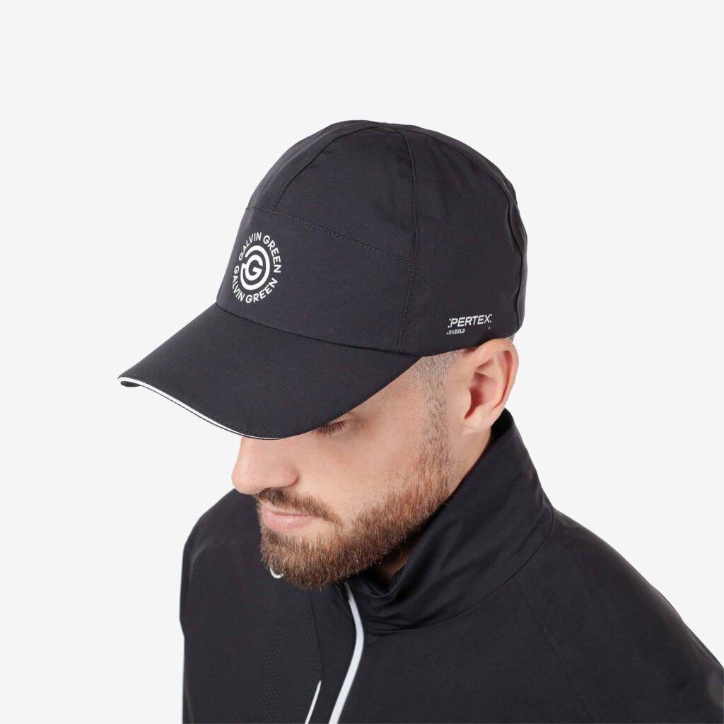 Man wearing black Galvin Green golf cap with Pertex branding