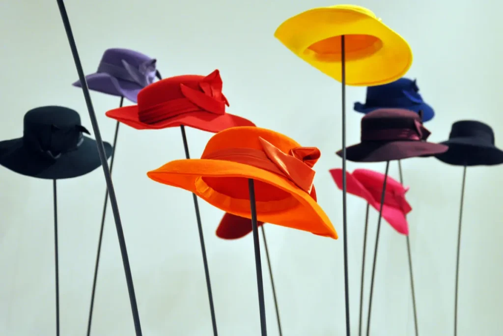 Various colorful hats on stands