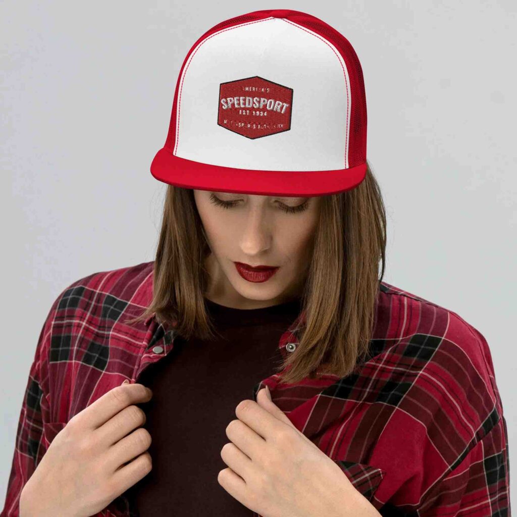 Woman wearing red and white trucker hat