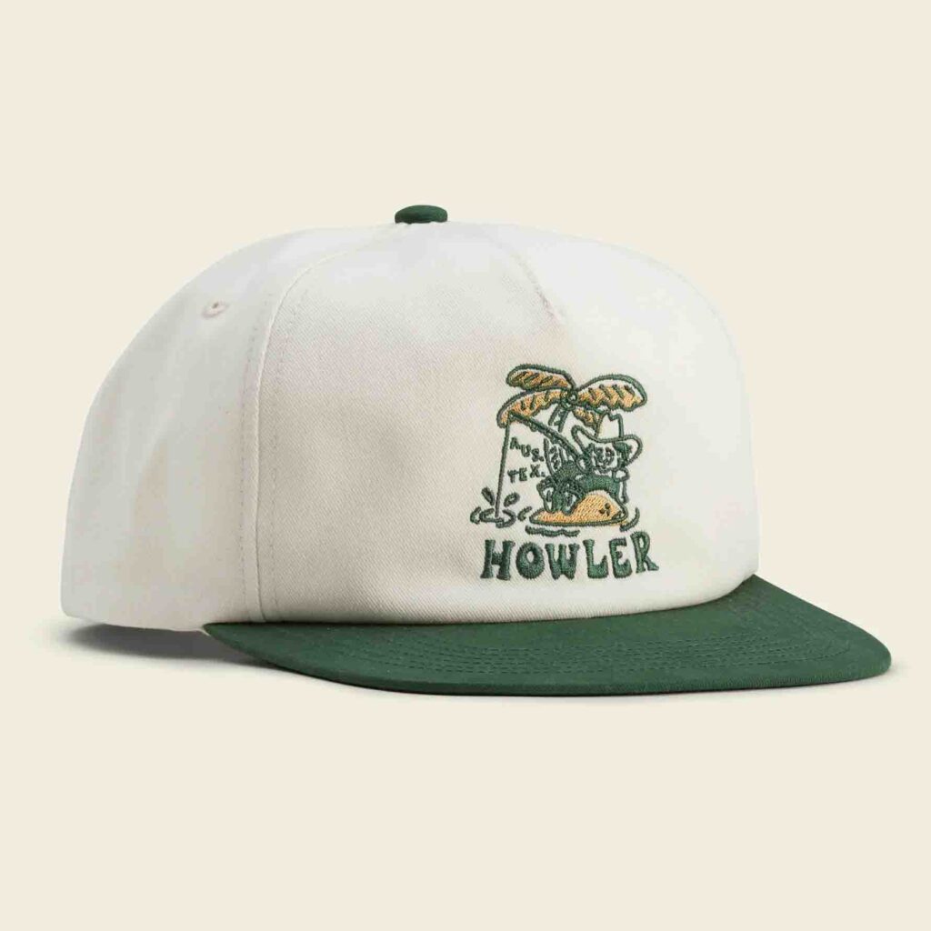 White hat with green brim and embroidered design
