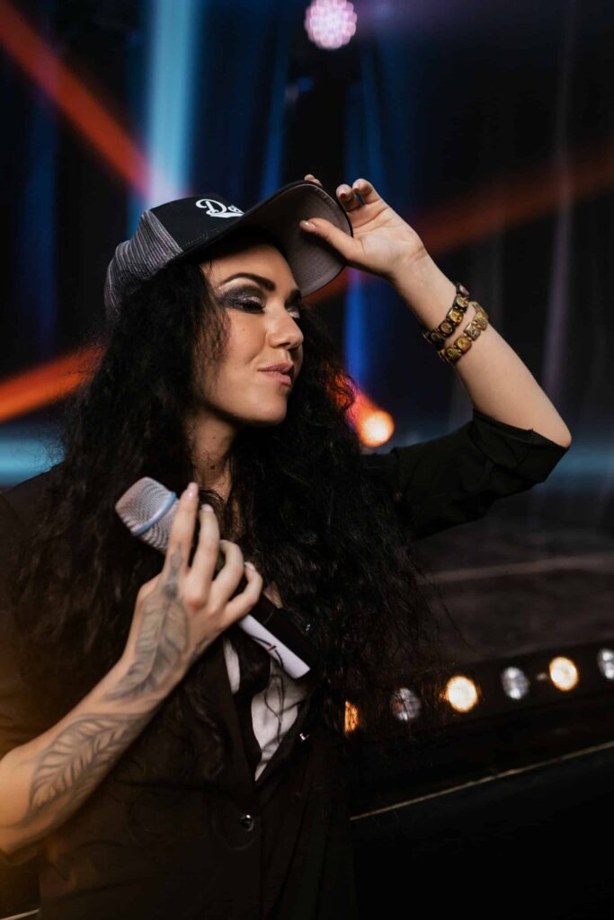 Woman in trucker hat holding microphone