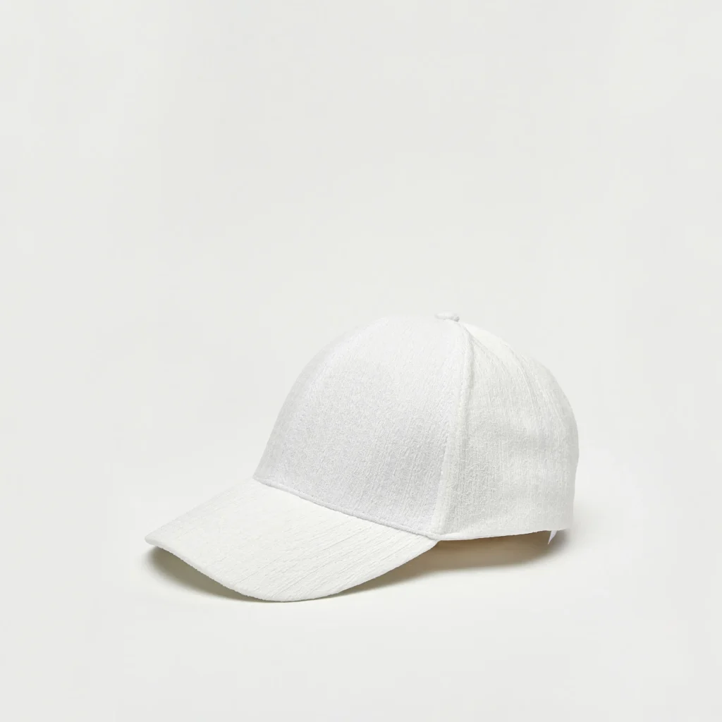Minimalist white baseball cap with a curved brim on a light background.