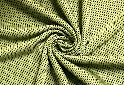 Close-up of green breathable mesh fabric with swirling folds.