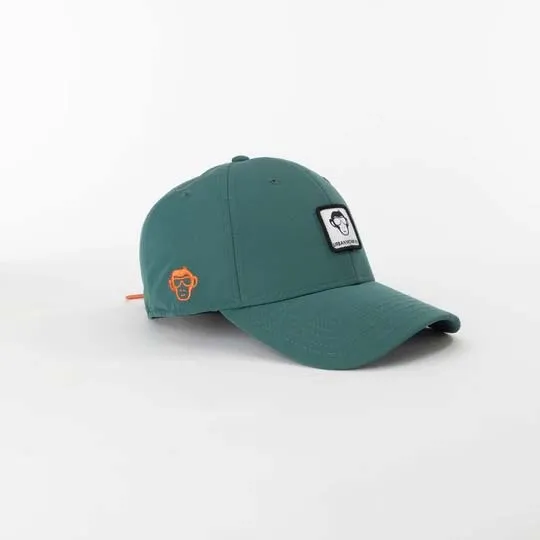 Green baseball cap with monkey logo patch and orange detail on white background.
