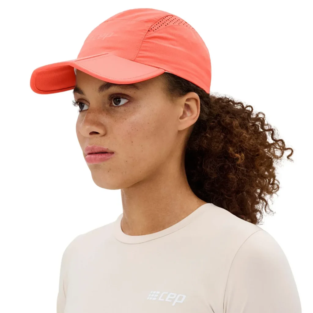 Woman wearing coral cap with ventilation holes.