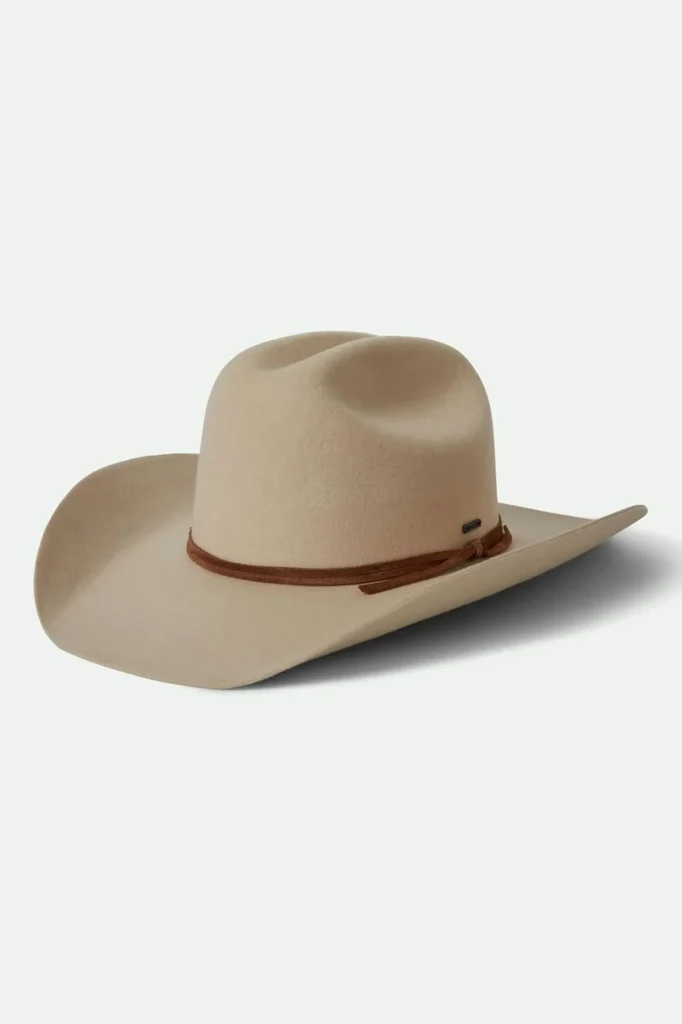 Beige cowboy hat with wide brim and brown leather band accessory