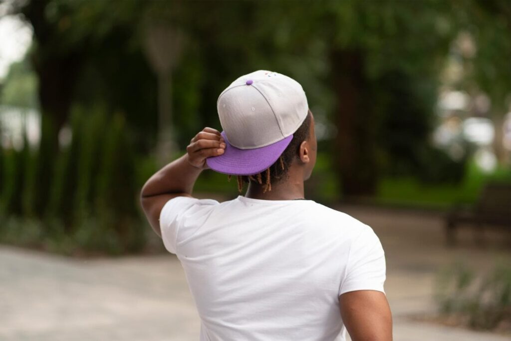 Man wearing snapback hat in park