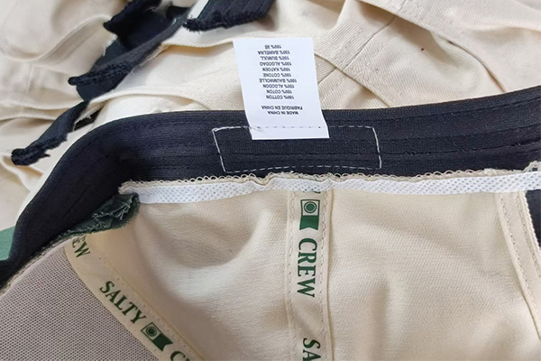 Inside view of cap showing brand tags and material composition labels.