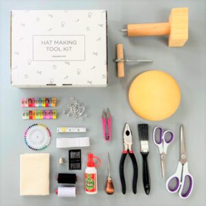 Complete tools for crafting hats, including fabric, scissors, glue, and measuring tape.