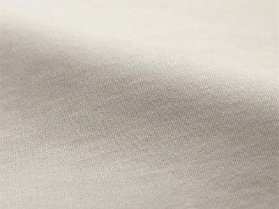 Close-up of smooth light beige cotton fabric surface