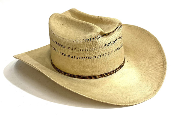 Light straw cowboy hat with decorative perforations and thin band.