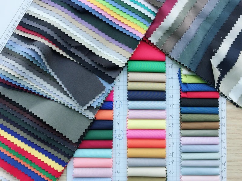 Colorful fabric samples with various textures and shades for selection.