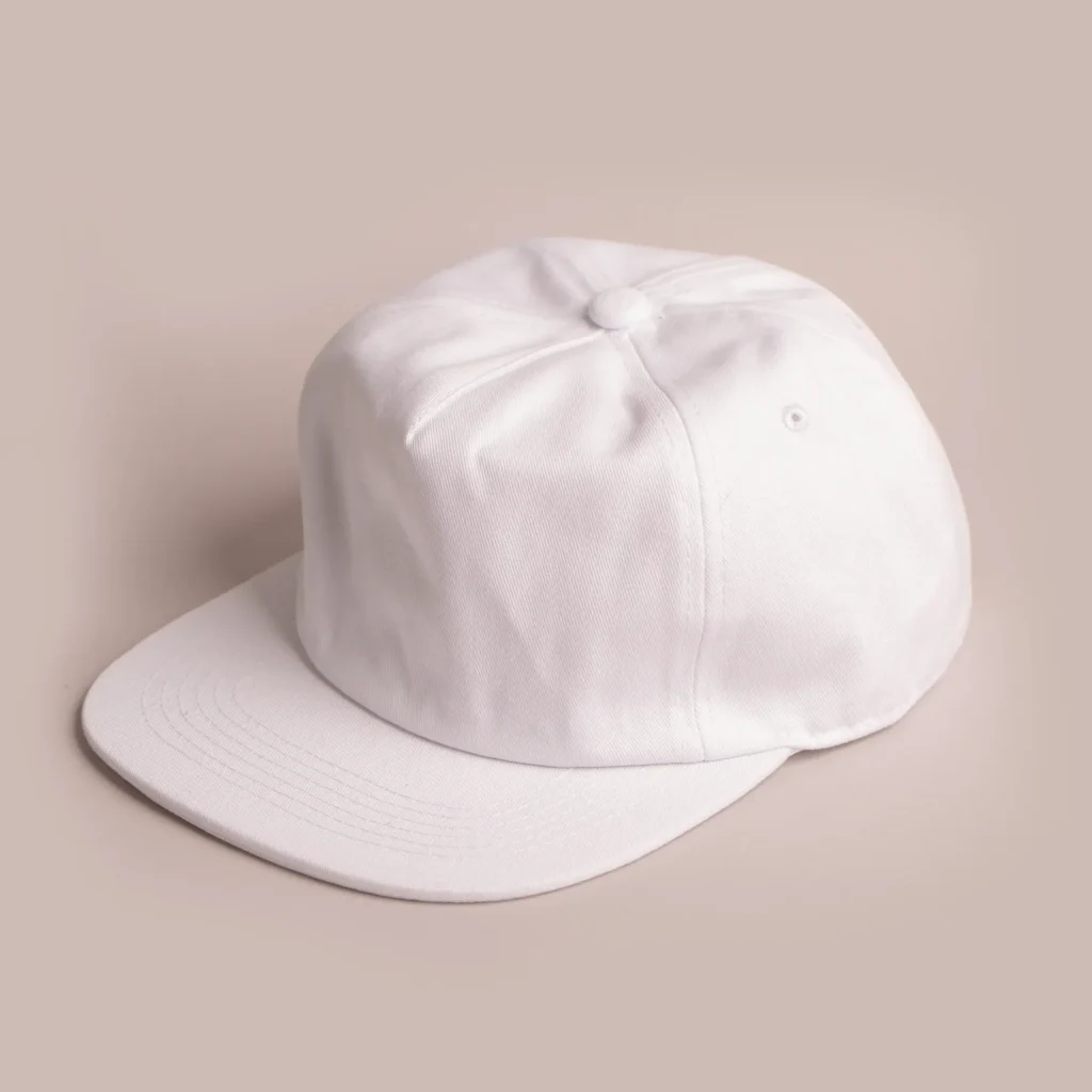 White six-panel baseball cap on beige background