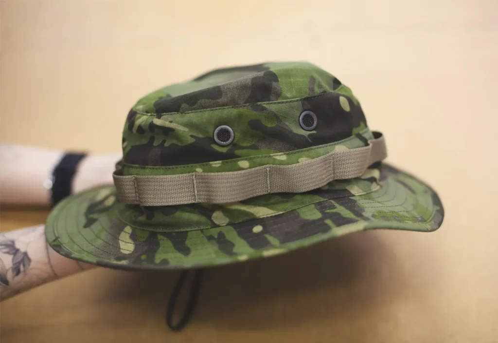 Green camo bucket hat with ventilation eyelets and strap