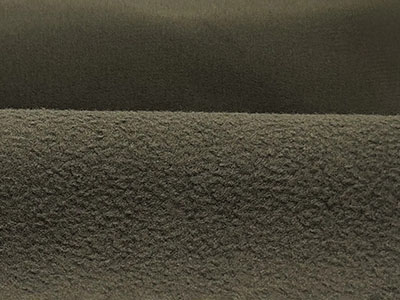 Close-up of dark-colored soft fleece fabric with textured surface.
