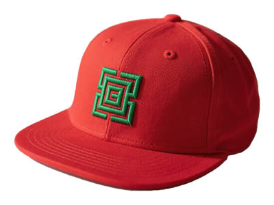 Red baseball cap with green embroidered geometric logo on front panel.