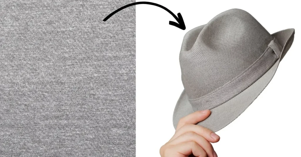 Gray fabric transforming into a stylish gray fedora hat being held.