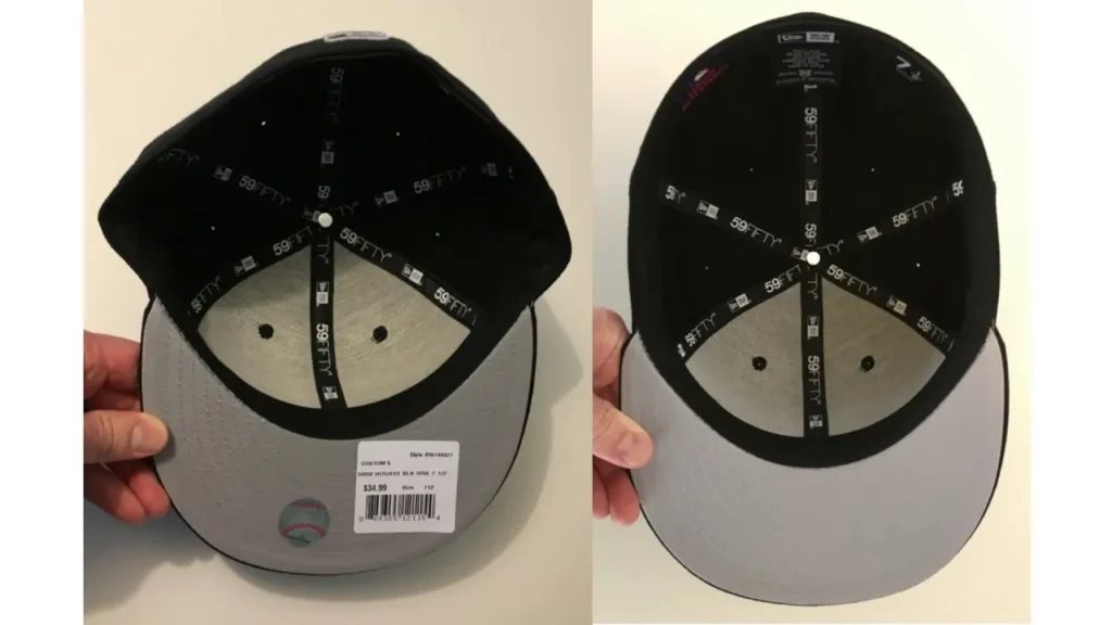 Inside of black and gray baseball cap showing stitching and labels.