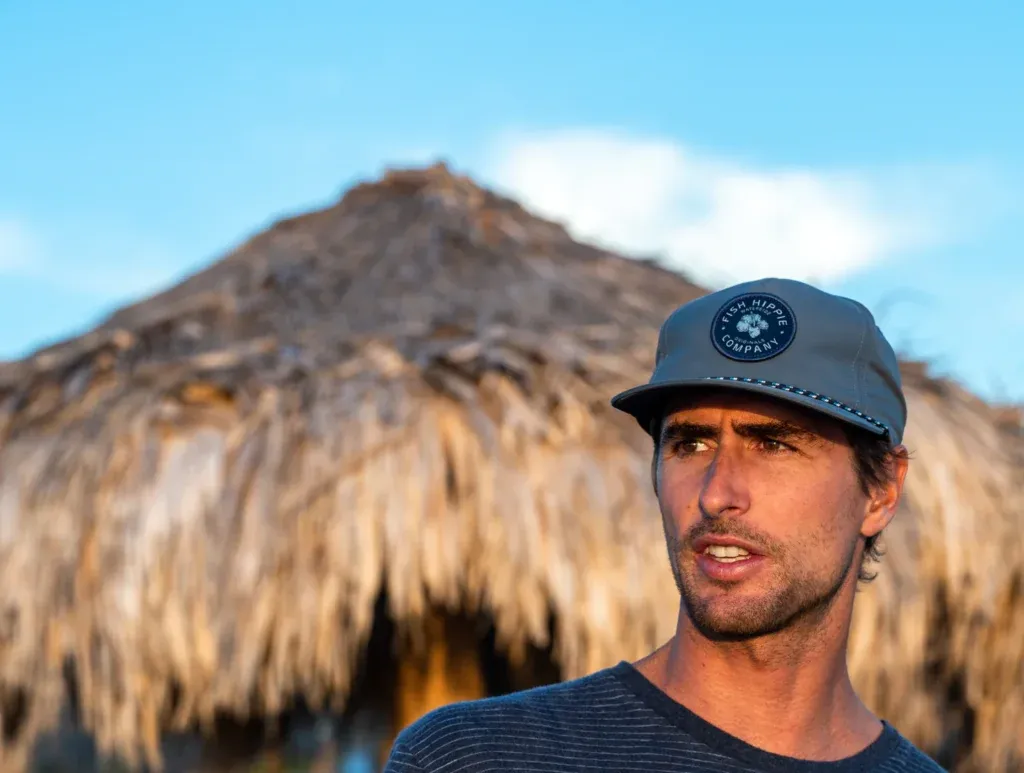 Man wearing gray cap with patch outdoors