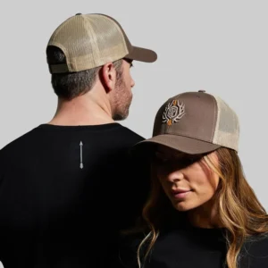 Man and woman wearing matching trucker hats with a unique embroidered design.