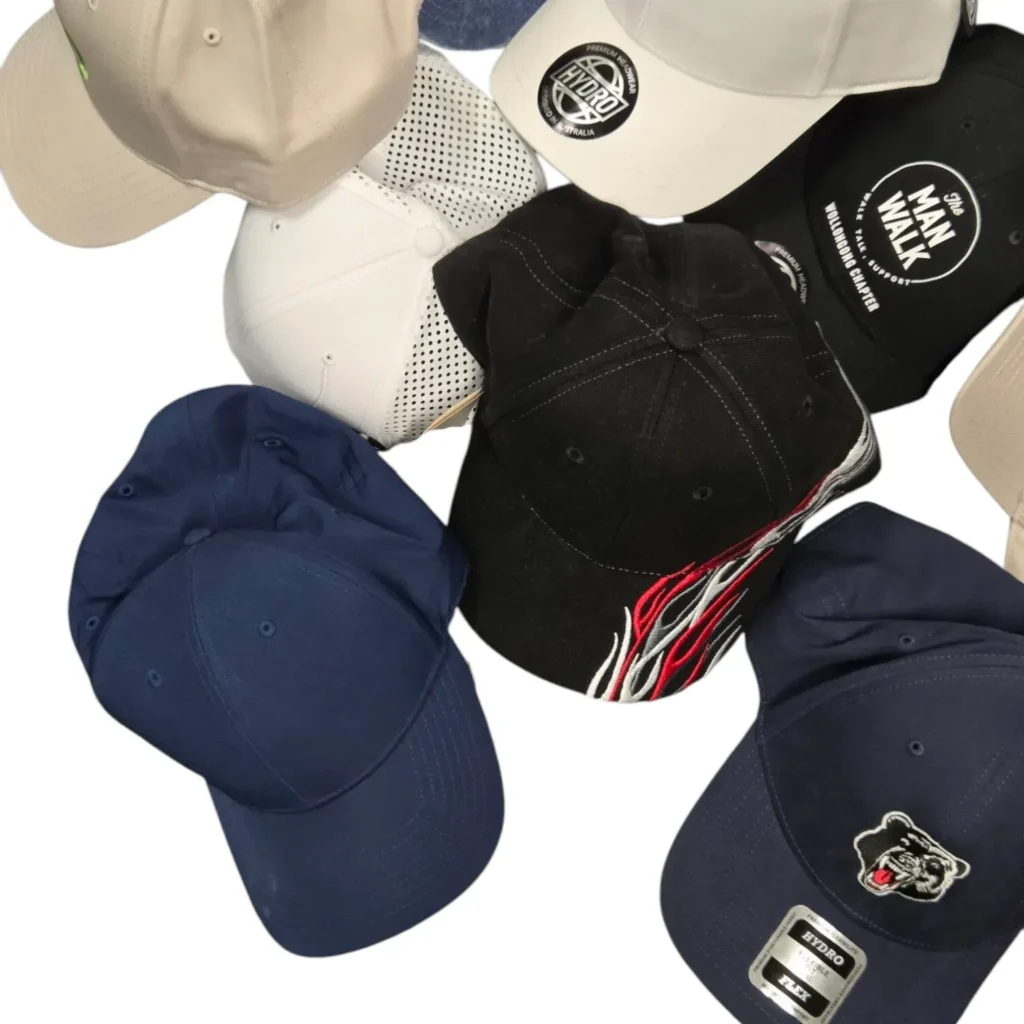 Various baseball caps with logos and embroidery in different colors.