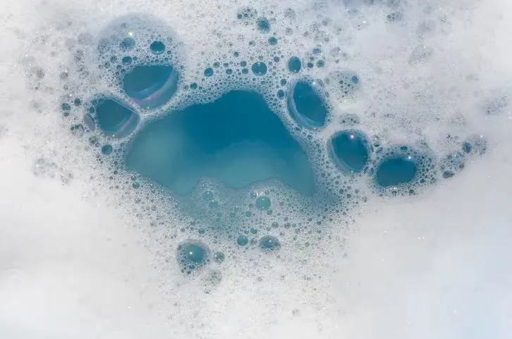 Bubbles in tub with detergent for washing