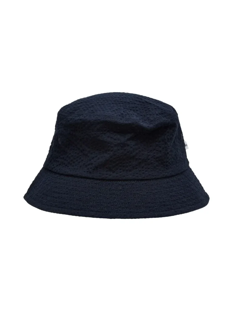 Black bucket hat made from textured fabric with a subtle dot pattern, shown against a white background.
