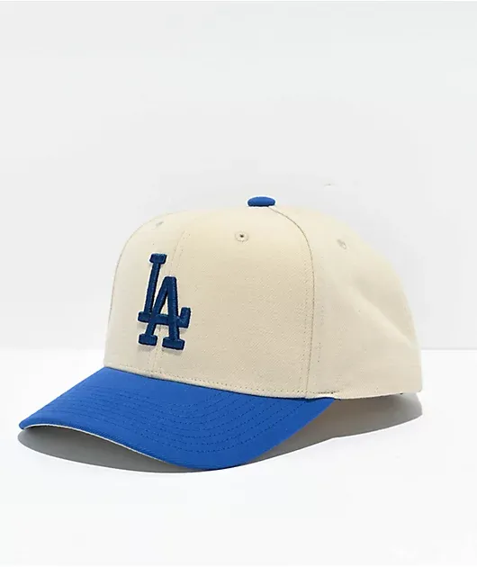 Beige and blue snapback cap with LA Dodgers logo.