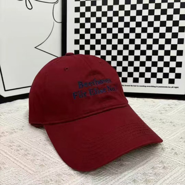 Maroon baseball cap with navy blue embroidered text on front.