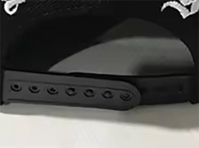 Black adjustable snapback strap with multiple holes for size fitting.