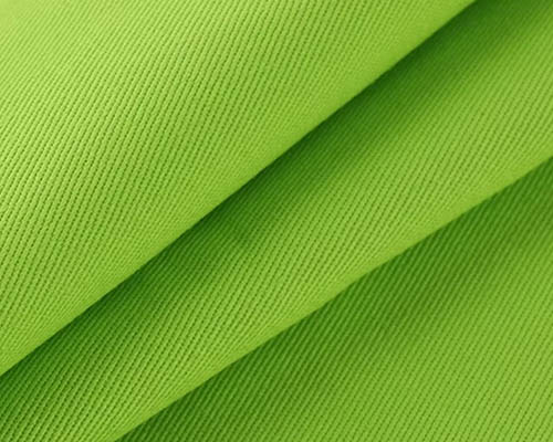 Close-up of bright green twill fabric showing diagonal weave texture.