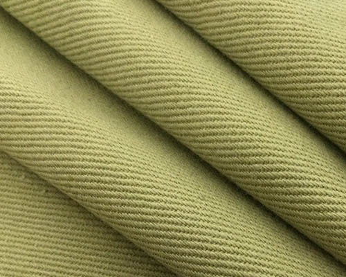 Close-up of olive green twill fabric with diagonal weave texture.