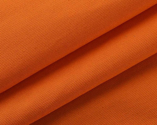 Close-up of vibrant orange twill fabric with diagonal weave texture.