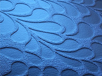 Close-up of textured blue fabric with floral embossed pattern.
