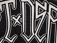 Close-up of black fabric with white gothic style printed text.