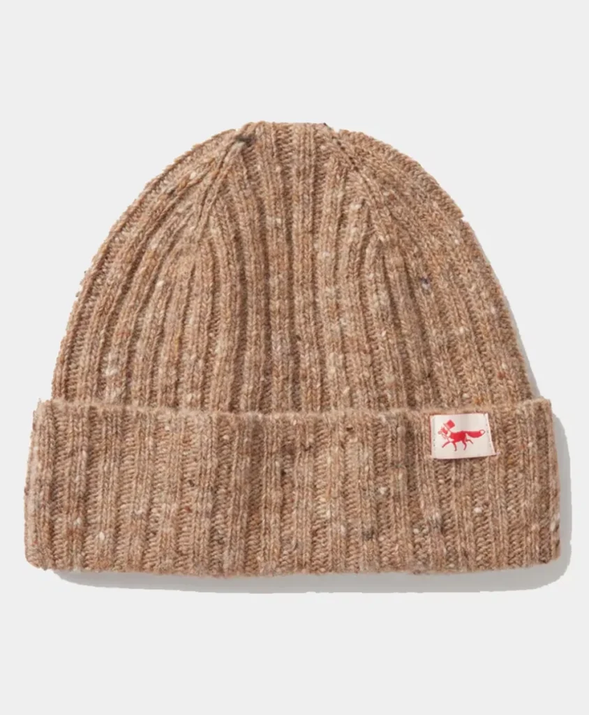 Cozy brown rib-knit beanie hat with a folded cuff featuring a small fabric label, perfect for cold weather.