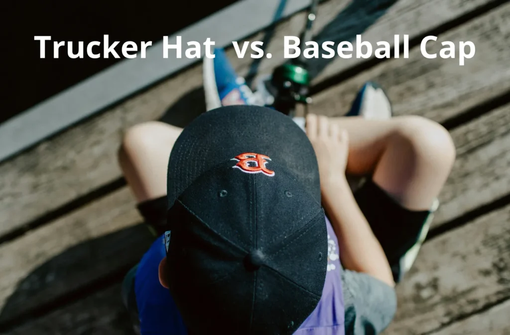 Top view of person wearing black baseball cap with orange logo sitting on wooden deck.