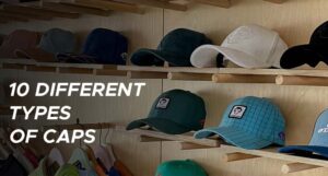 Various styles of caps displayed on wooden shelves in a store.
