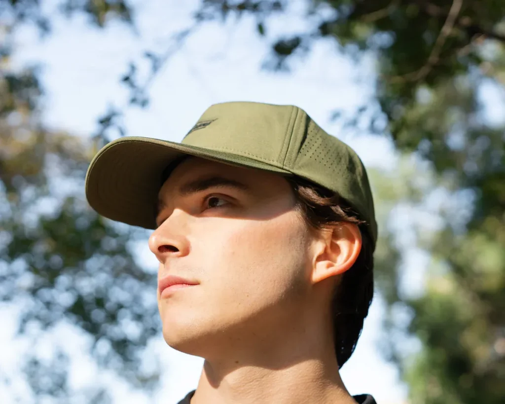 Man wearing olive breathable cap outdoors
